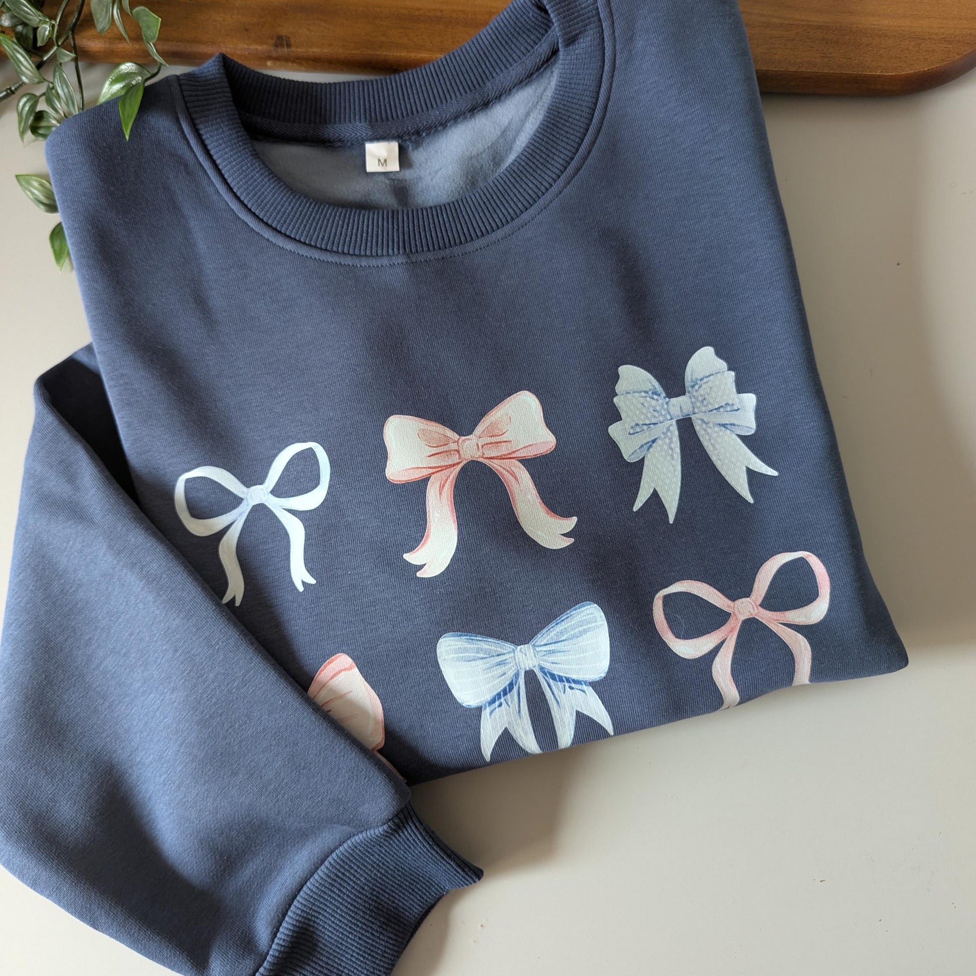 Pastel multi bows cute fleece women's jumper. Soft fleece want jumper. Denim Blue or cream jumper. Girly bows.